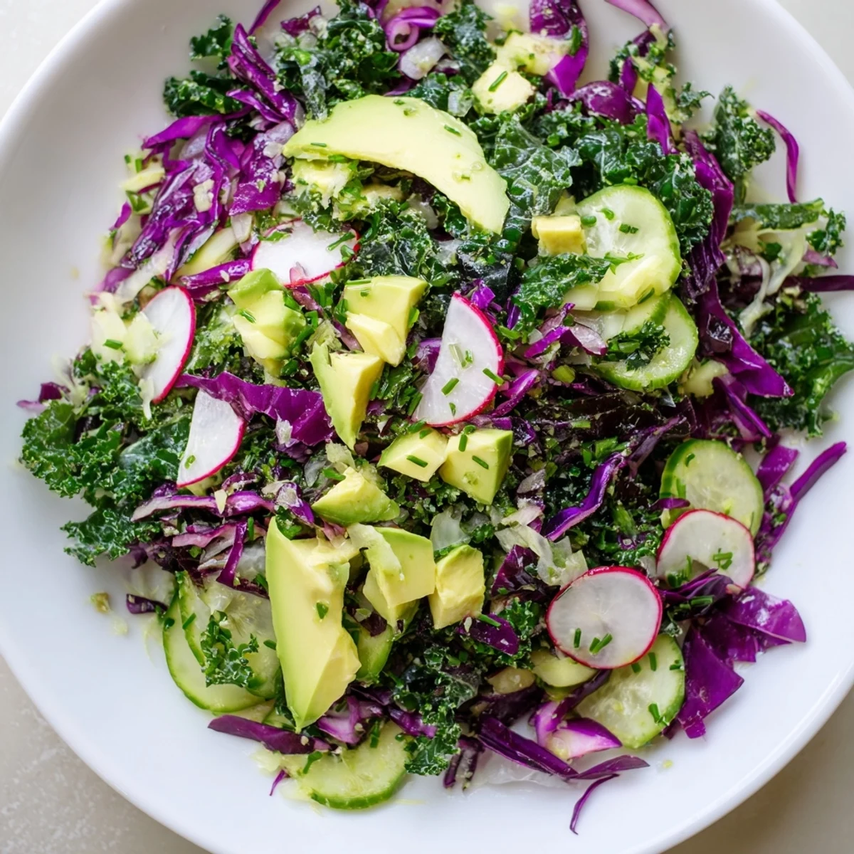 A colorful bowl of Green Goddess Detox Cabbage Salad, bursting with fresh, crisp vegetables.