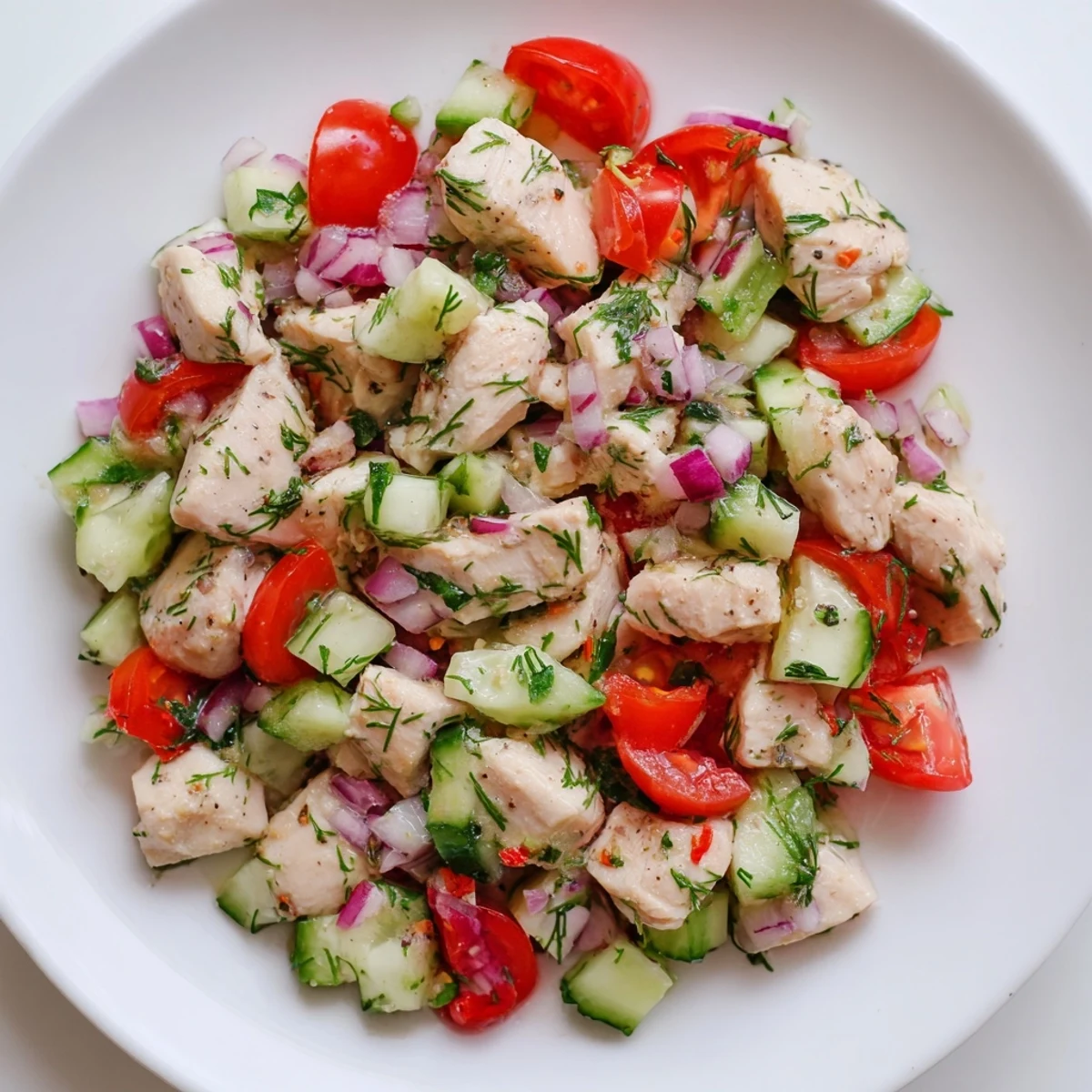 A refreshing Cucumber and Chicken Clean Shaker showcasing a close-up of the flavorful, colorful salad with herbs.
