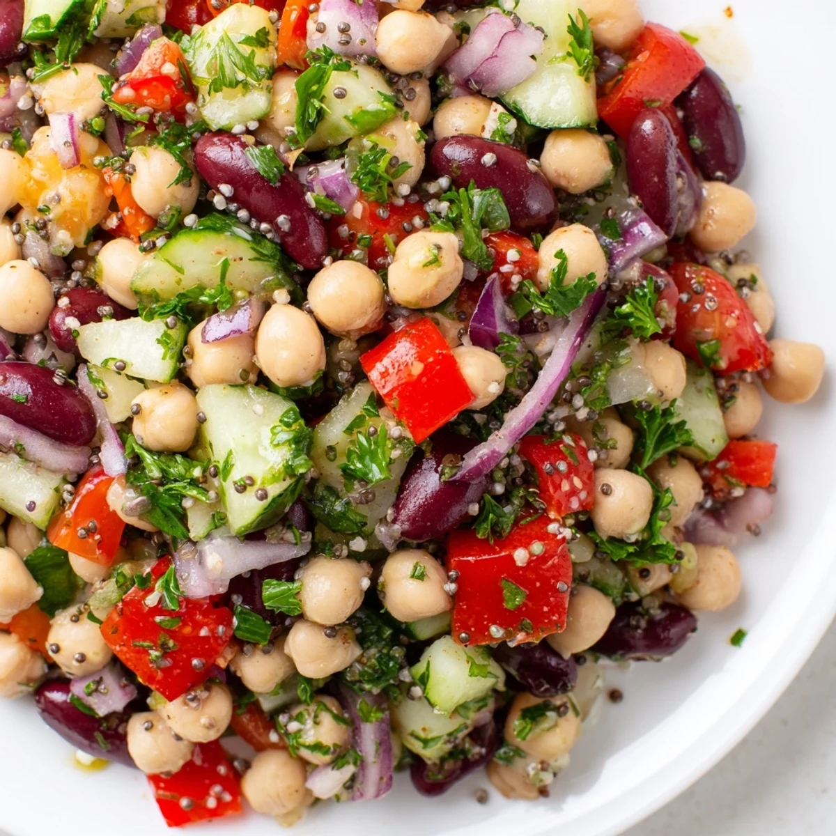 A colorful bowl of Dense Bean Salad with Wellness Seeds, showcasing a medley of textures and flavors.