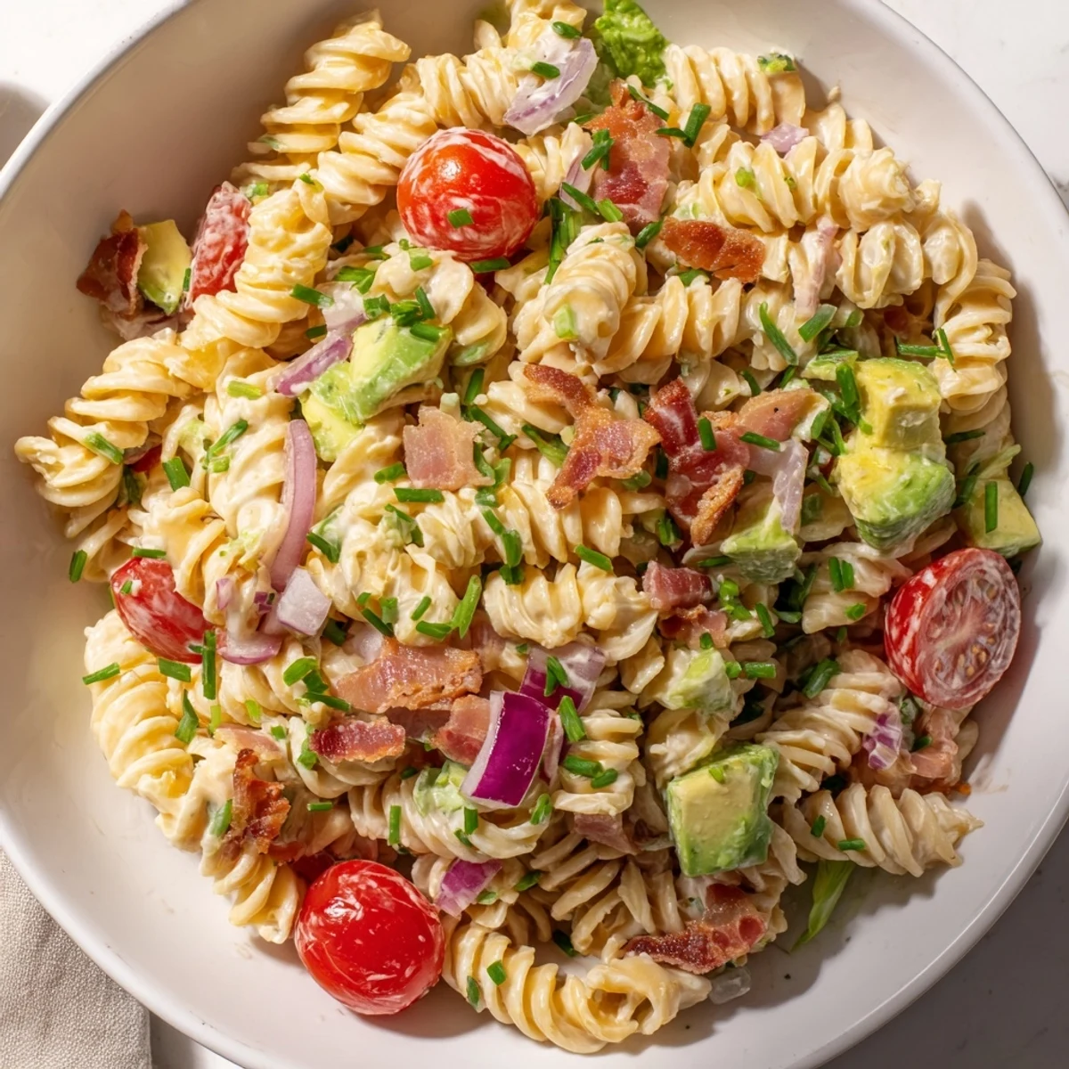 Enjoy a big bowl of BLT Pasta Salad: a delicious, summery mix of textures and fresh flavors.