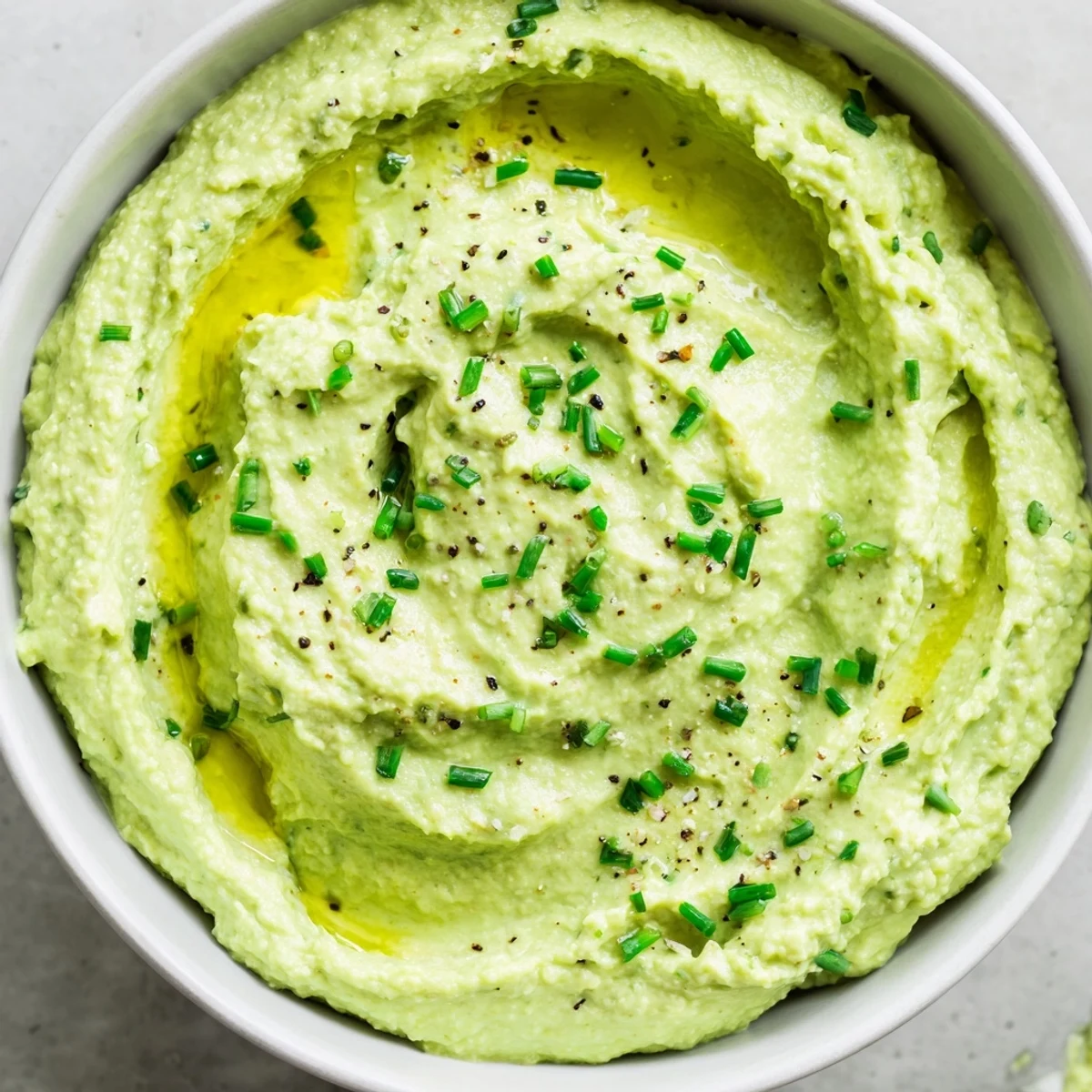 Creamy Avocado Cottage Cheese Dip, a vibrant green dip ready to be paired with fresh vegetables.