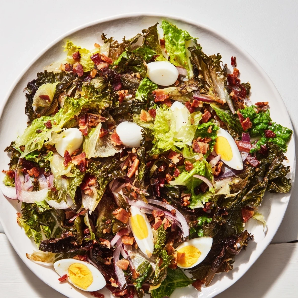 A flavorful Bitter Greens Salad, highlighted by warm bacon dressing's rich aroma.