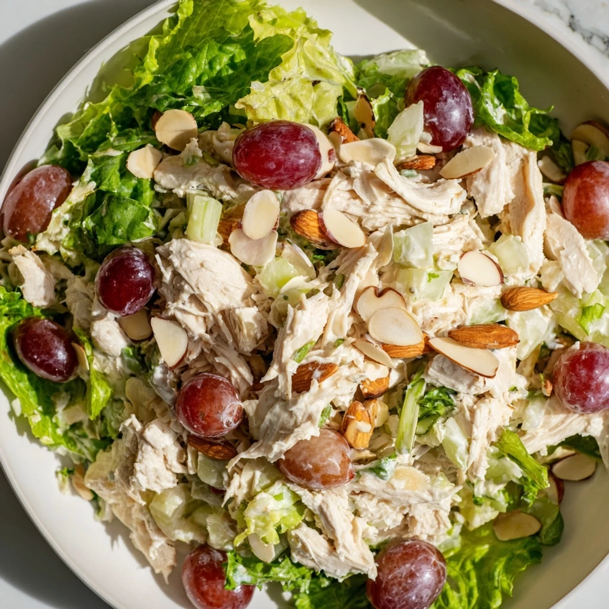 This delicious Crispy Chicken Salad combines shredded chicken with grapes and celery, served atop a bed of mixed greens.