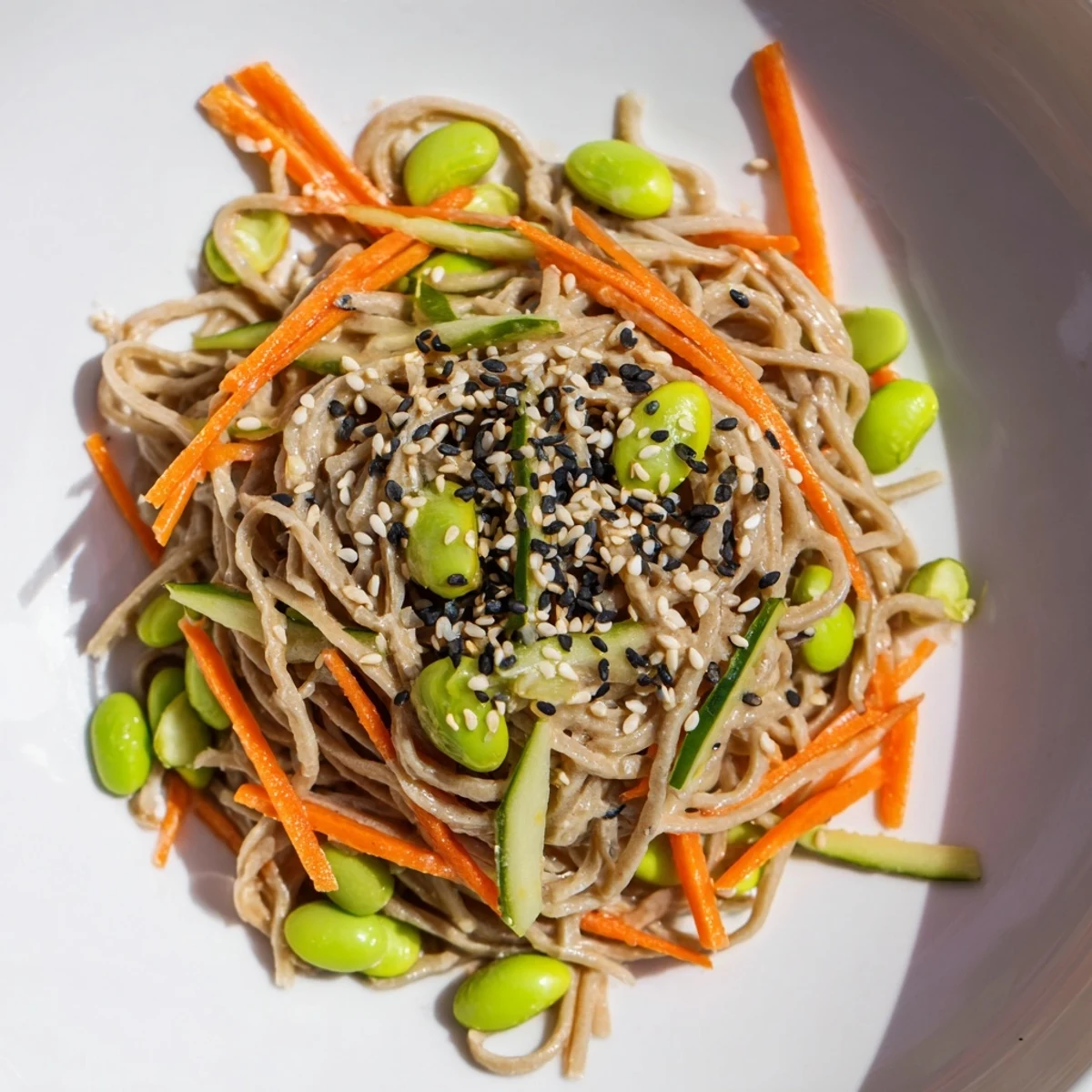 Soba noodles tossed in the flavorful Asian Sesame Noodle Salad, served with crisp vegetables for a light meal.