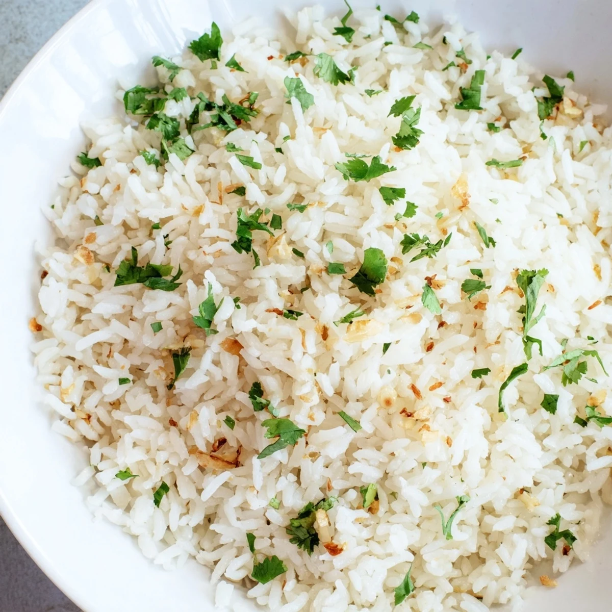 Golden garlic oil coats each fluffy grain of this savory jasmine rice, ready to accompany your favorite stir-fry.