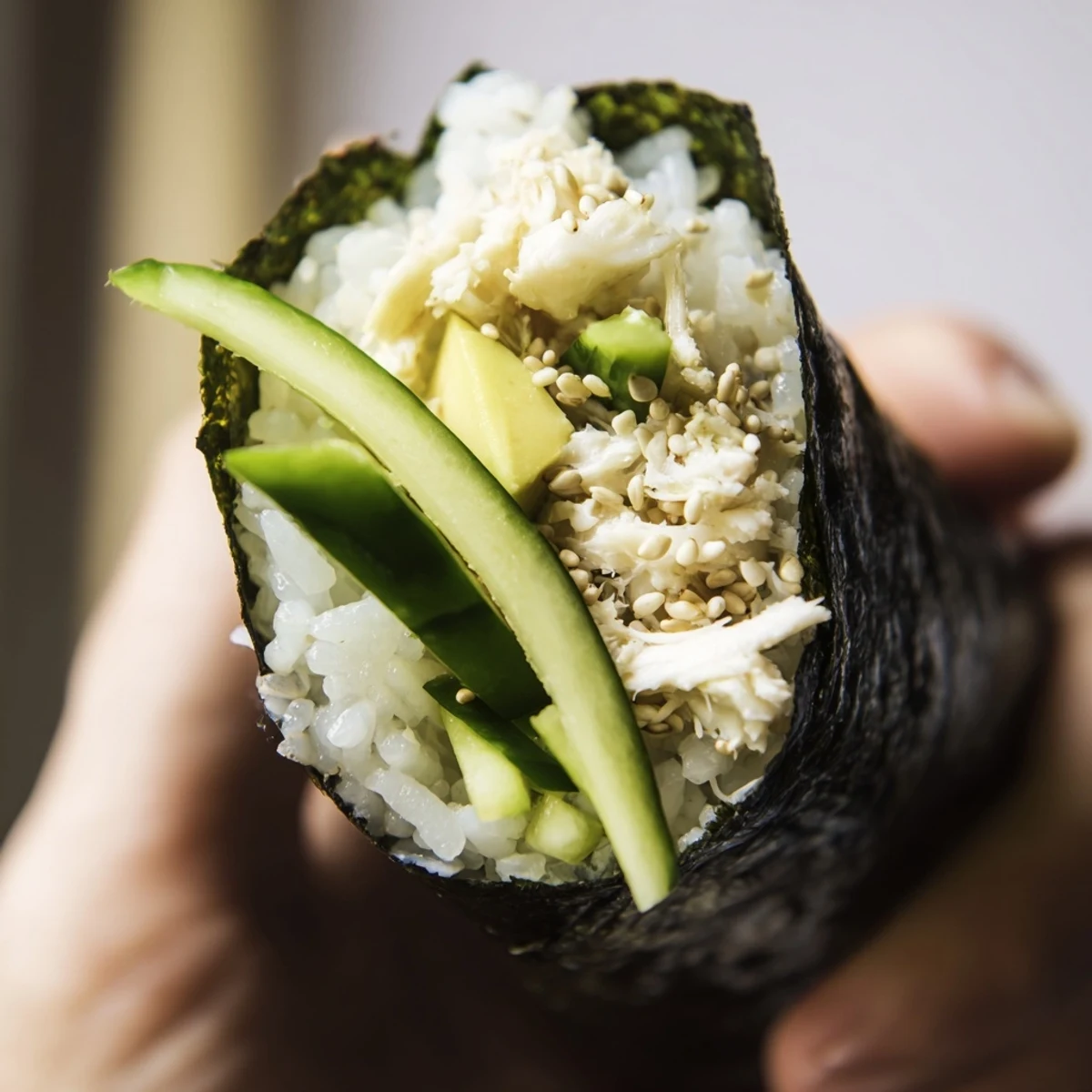 Delicate sushi rice hand rolls feature creamy avocado, sweet crab, and crunchy cucumber wrapped in a crisp nori sheet.  