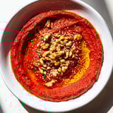 Delicious, creamy Syrian Muhammara with toasted walnuts and a drizzle of olive oil.