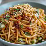 Refreshing Thai Peanut Noodle Salad drizzled with creamy, zesty peanut sauce.