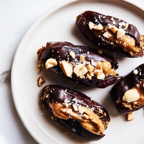 Chocolate Date Snickers coated in dark chocolate, a delicious dessert treat full of peanut butter.