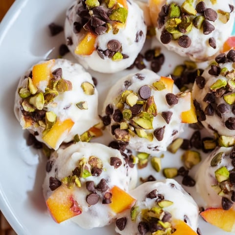Close-up of frozen peach yogurt bites, showcasing the creamy texture and sweet peach pieces.