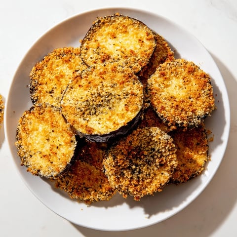 Golden, crispy Eggplant Parmesan Chips fresh from the oven, ready for dipping in marinara.