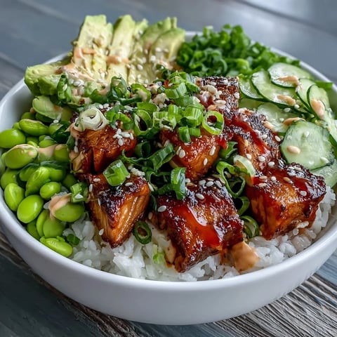 Fork-tender marinated salmon cubes rest on fluffy jasmine rice with edamame in this vibrant Salmon Rice Bowl.