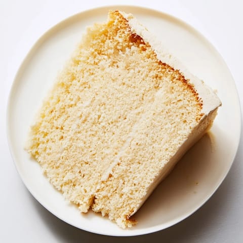 Fluffy slice of Simple 3-Ingredient Vanilla Sponge Cake, golden brown and ready to serve.