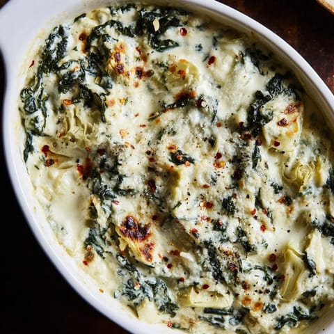 A close-up of a warm Spinach and Artichoke Dip, perfectly served for a cozy appetizer.