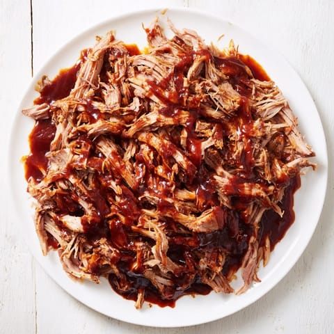 A close-up of steaming 5-Ingredient BBQ Pulled Pork, savory and delicious, perfect for sandwiches.
