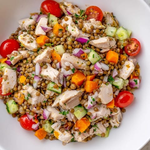 This Chicken and Lentil Recession Salad showcases tender chicken with fresh vegetables, ready to eat.