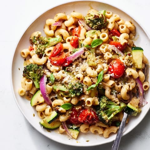 Vibrant image of ditalini with air-fried vegetables, tossed with fresh basil and Parmesan cheese.