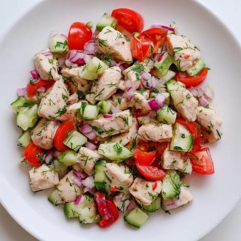 A refreshing Cucumber and Chicken Clean Shaker showcasing a close-up of the flavorful, colorful salad with herbs.