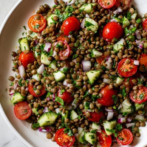 This vibrant lentil salad, shown with fresh herbs, is ready for a nutritious, satisfying meal.
