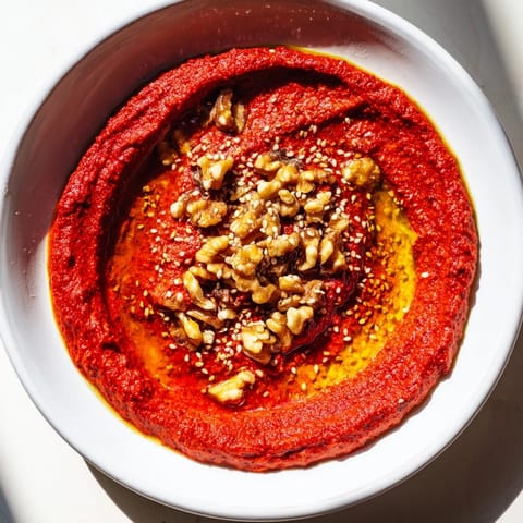 Delicious, creamy Syrian Muhammara with toasted walnuts and a drizzle of olive oil.