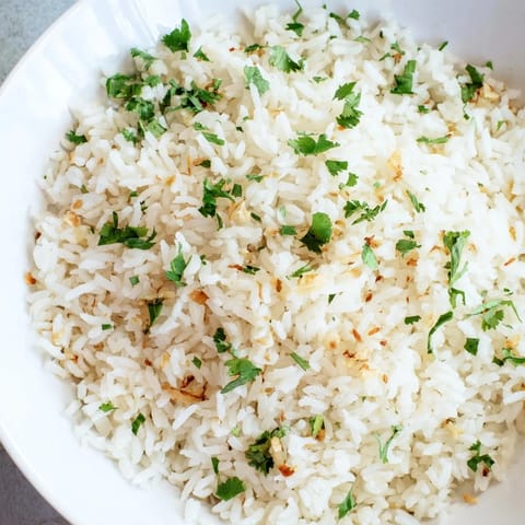 Golden garlic oil coats each fluffy grain of this savory jasmine rice, ready to accompany your favorite stir-fry.
