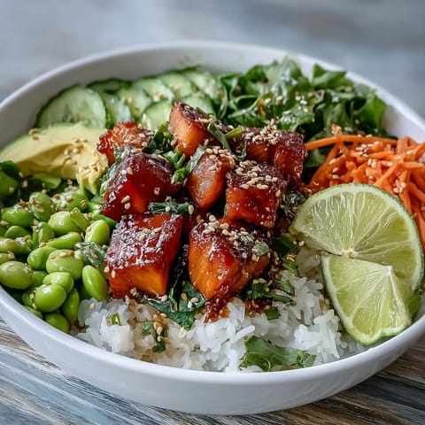 Crisp vegetables and tender salmon share a bowl of steamed rice, drizzled with spicy sriracha mayo for a balanced weeknight meal.