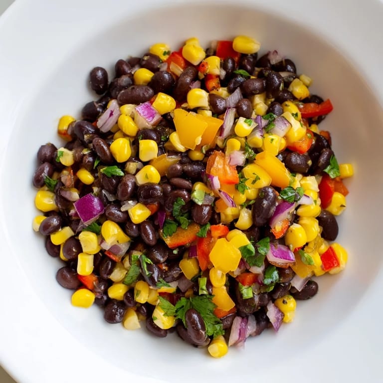 Close-up of a refreshing Southwest Black Bean Salad; imagine the crisp vegetables and bright cilantro.