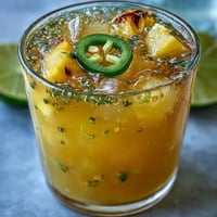 Refreshing pineapple jalapeño agua fresca with vibrant tropical flavors and a hint of spicy kick in a clear pitcher.